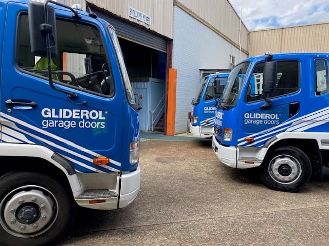 A Gliderol technician with a branded service truck on-site, providing expert garage door repair and support. - Gliderol